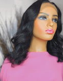 Silky center part frontal lace wig on mannequin styled with loose curls